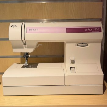 Begagnad Pfaff Select 1530 fotat på en hylla med träbakgrund